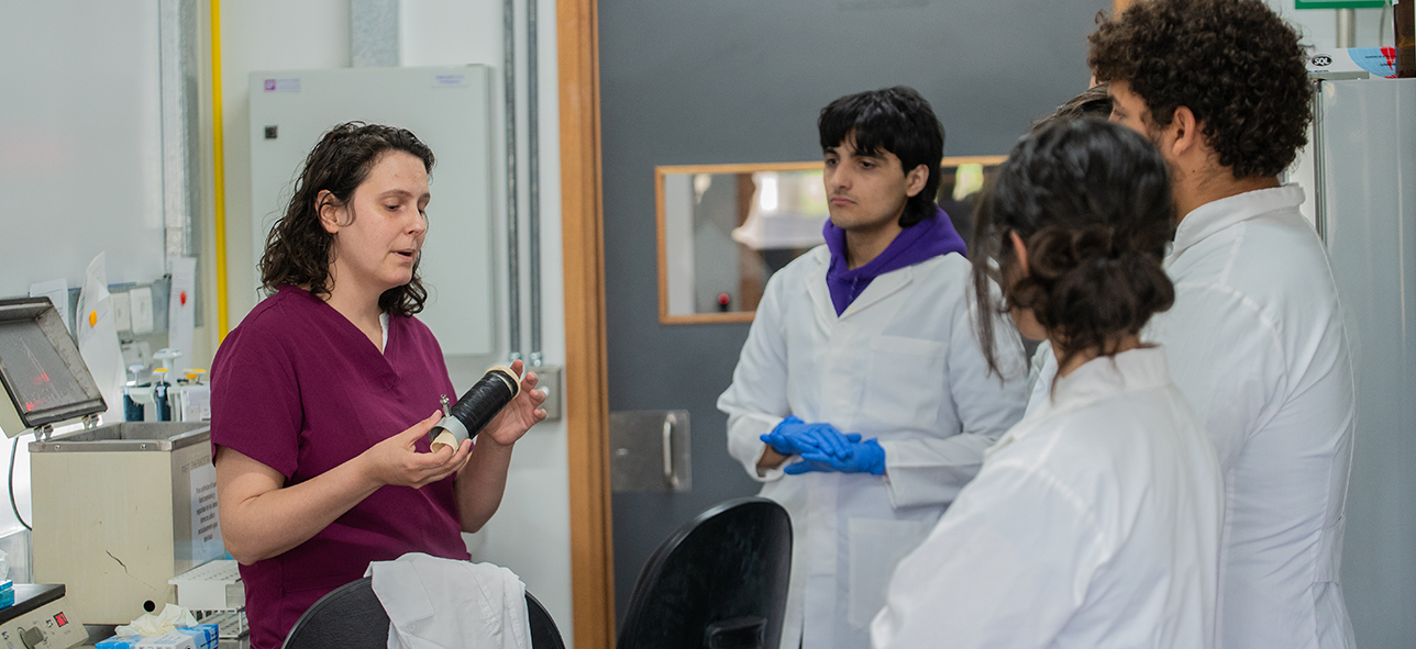Científica habla, mientras estudiantes miran